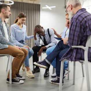 People Comforting Friend in Therapy Session