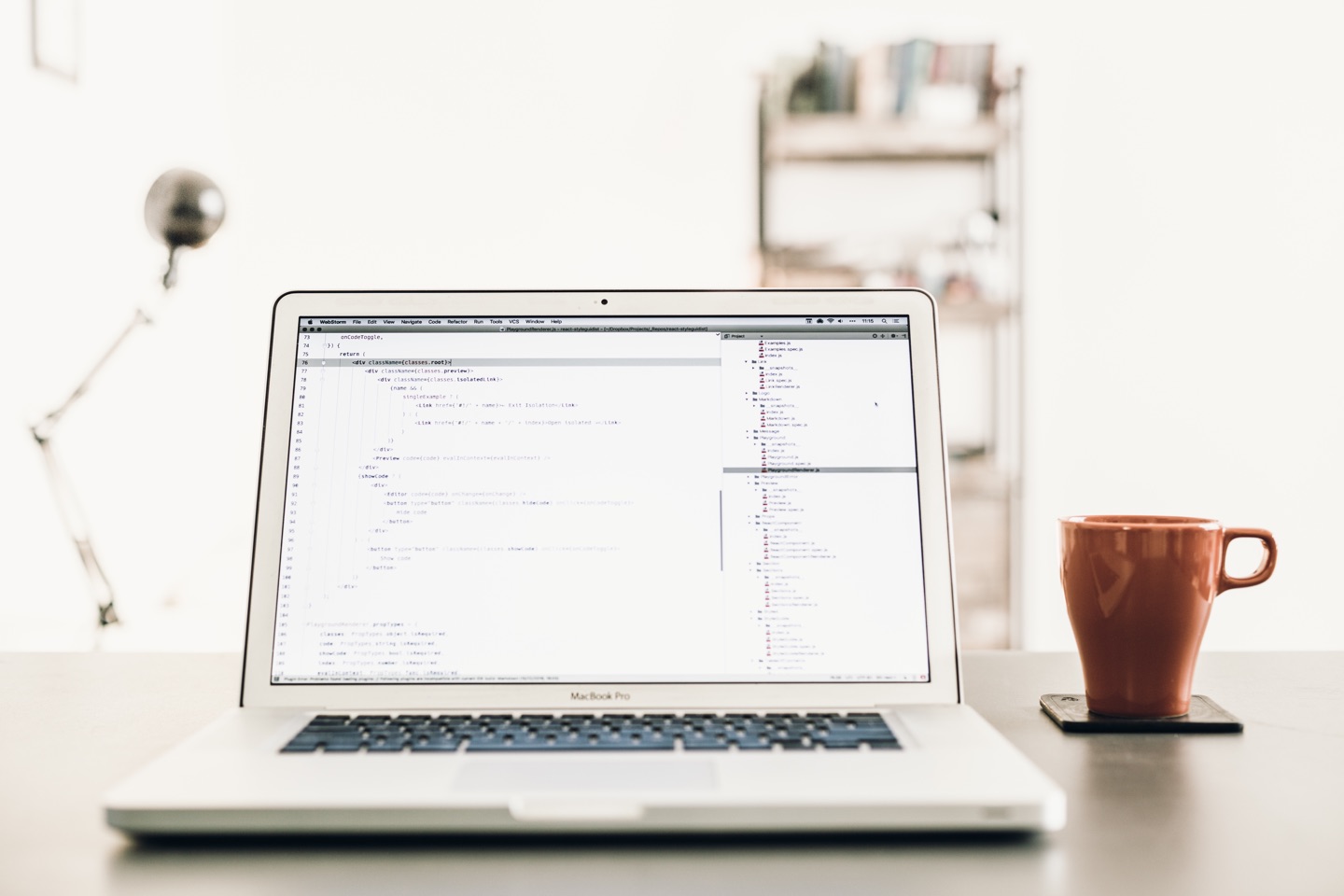 Laptop on desk with coffee mug